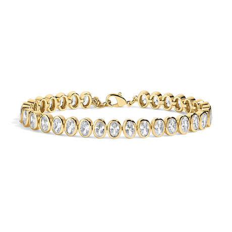 A yellow gold tennis bracelet featuring a row of bezel-set oval clear gemstones, displayed on a clean white background.