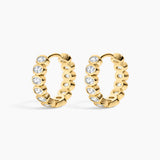 Gold hoop earrings with embedded diamonds on a white background