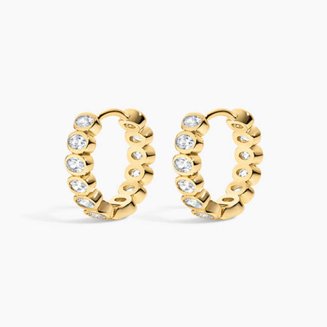 Gold hoop earrings with embedded diamonds on a white background