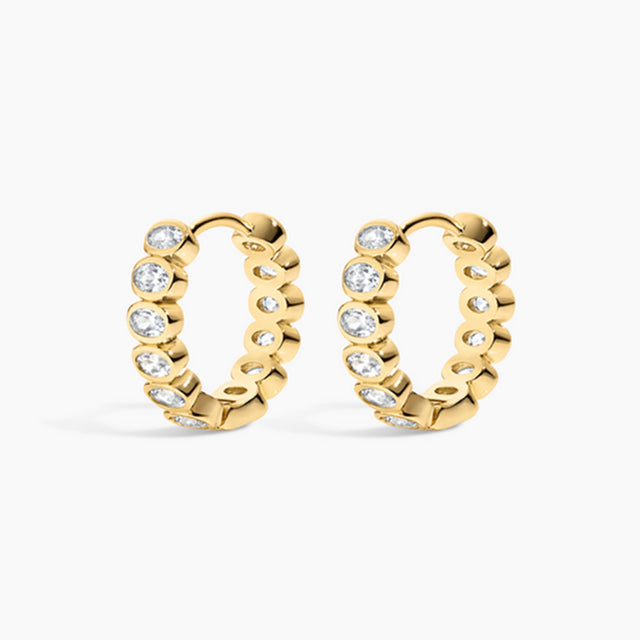 Gold hoop earrings with embedded diamonds on a white background