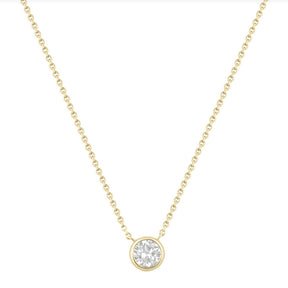 Gold necklace with a round diamond pendant on a white background