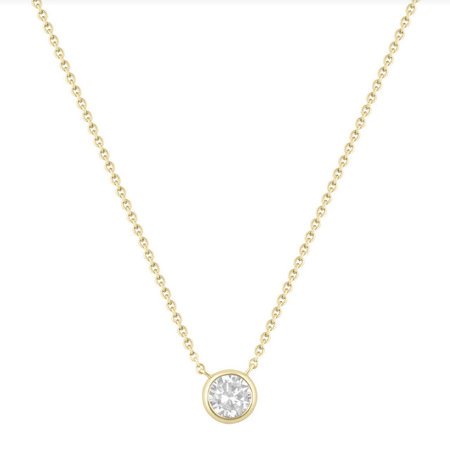 Gold necklace with a round diamond pendant on a white background