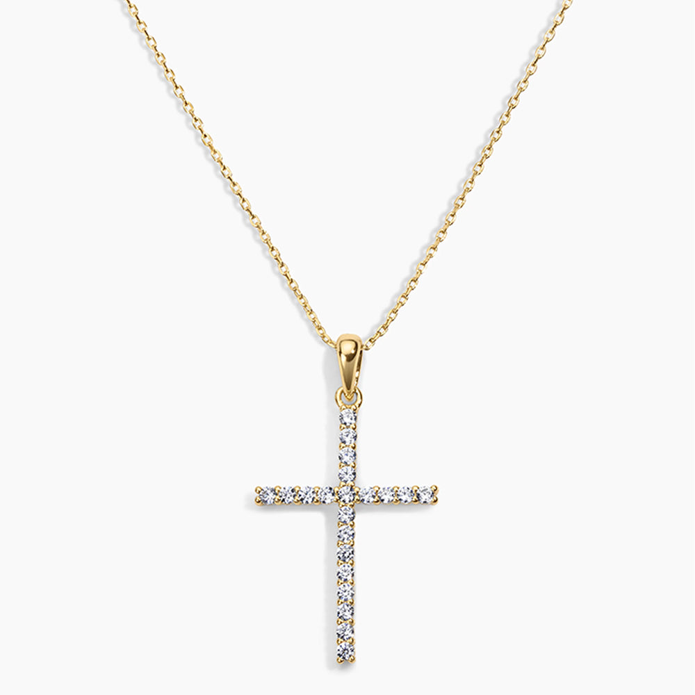 Gold cross pendant necklace on a white background