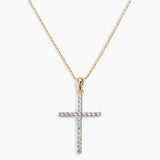 Gold cross pendant necklace on a white background