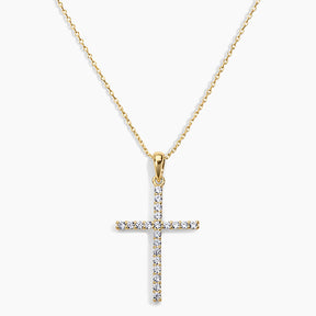 Gold cross pendant necklace on a white background