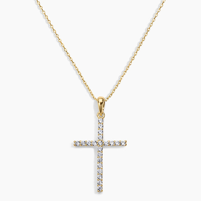 Gold cross pendant necklace on a white background