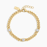 Gold chain bracelet with embedded crystals on a white background