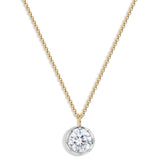 A delicate gold chain necklace with a round bezel-set clear gemstone pendant on a white background.