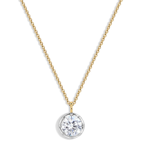 A delicate gold chain necklace with a round bezel-set clear gemstone pendant on a white background.