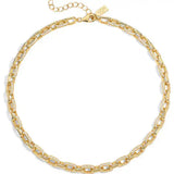A gold chain necklace with alternating smooth elongated links and links set with small clear stones, displayed on a clean white background.
