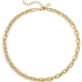 A gold chain necklace with alternating smooth elongated links and links set with small clear stones, displayed on a clean white background.