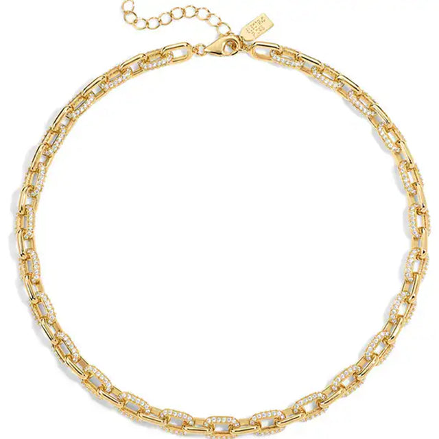 A gold chain necklace with alternating smooth elongated links and links set with small clear stones, displayed on a clean white background.