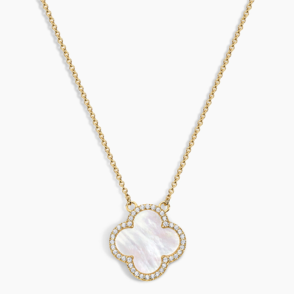 Gold necklace with a clover-shaped pendant on a white background