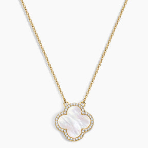 Gold necklace with a clover-shaped pendant on a white background