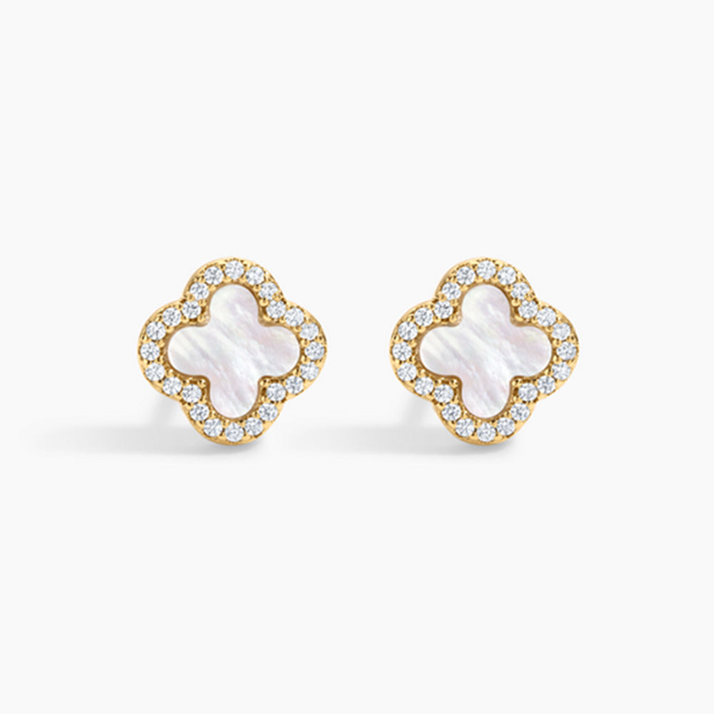 Pair of gold earrings with white center and clear stones on a white background