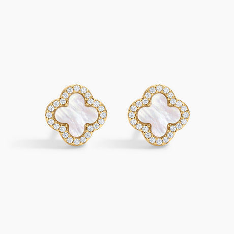 Pair of gold earrings with white center and clear stones on a white background