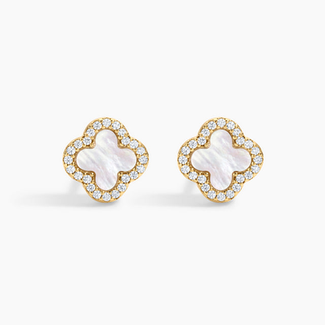 Pair of gold earrings with white center and clear stones on a white background