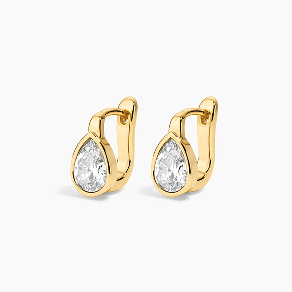 Gold drop earrings on a white background