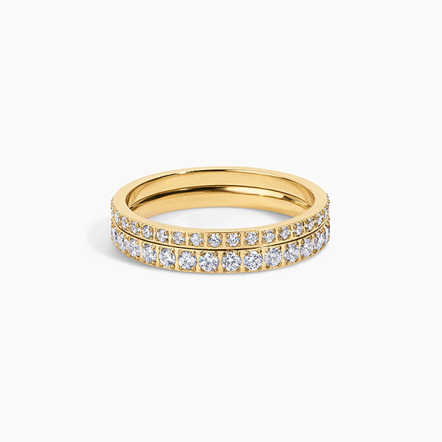 A yellow gold eternity ring featuring two rows of pavé-set round diamonds on a clean white background.