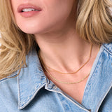 woman wearing double chain necklace
