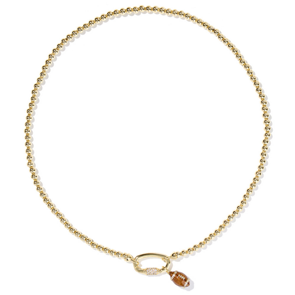 Gold necklace with a small brown pendant on a white background