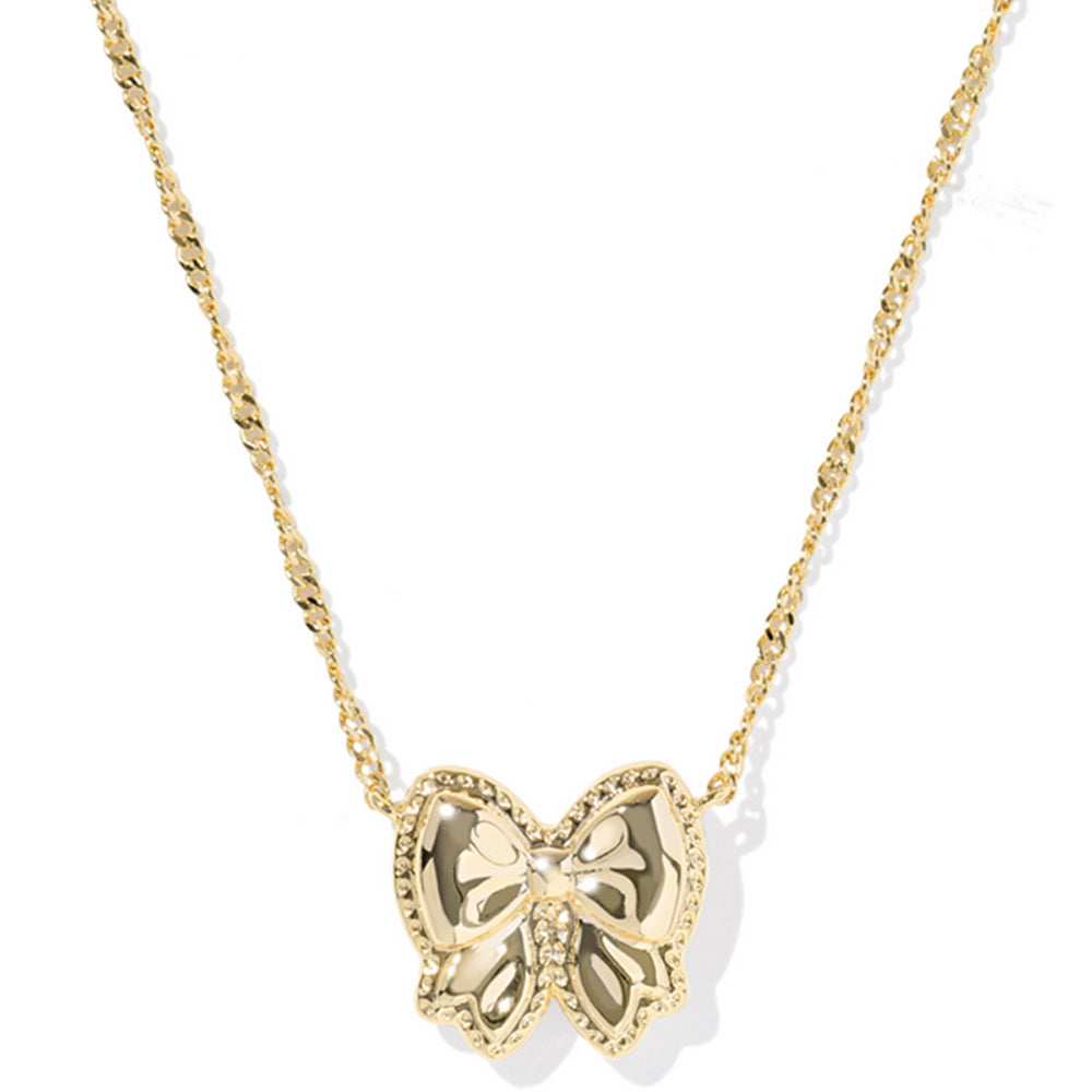 Gold bow necklace on a white background