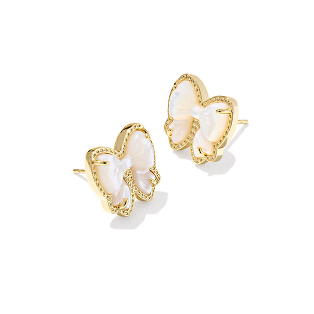 Bow-shaped earrings with gold frames and white centers on a white background