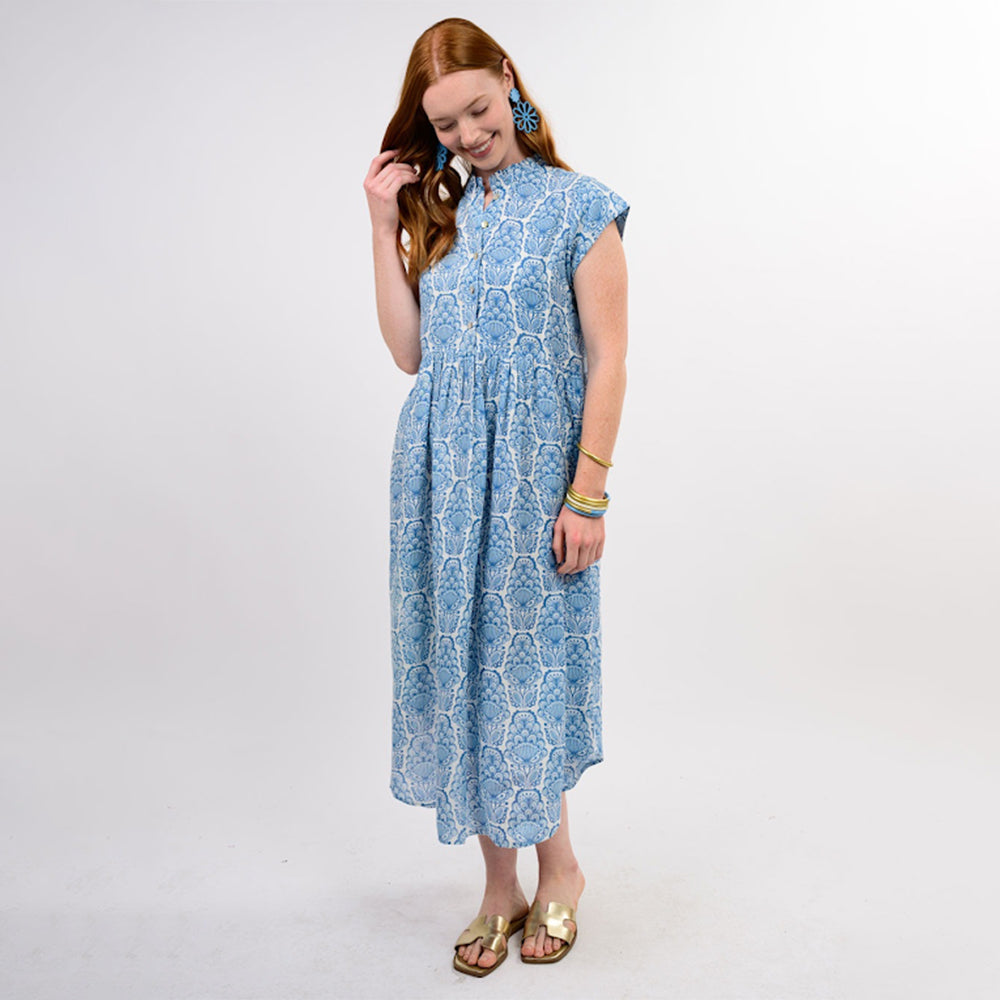 Woman wearing a blue patterned dress on a white background