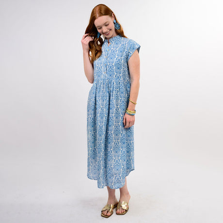 Woman wearing a blue patterned dress on a white background