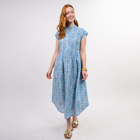 Woman wearing a blue patterned dress on a white background