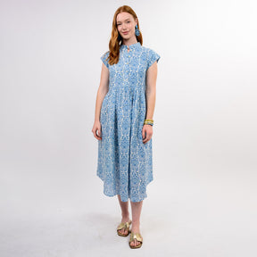Woman wearing a blue patterned dress on a white background