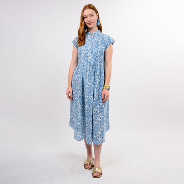 Woman wearing a blue patterned dress on a white background