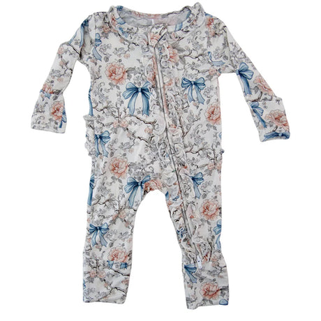 Floral and bow-patterned baby onesie on a white background