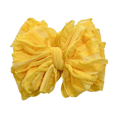 Yellow bow hair accessory on a white background