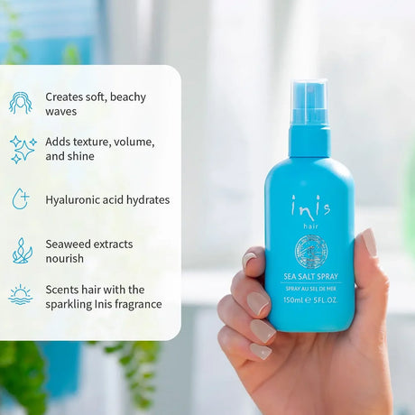 hand holding a lue bottle of Inis sea salt spray