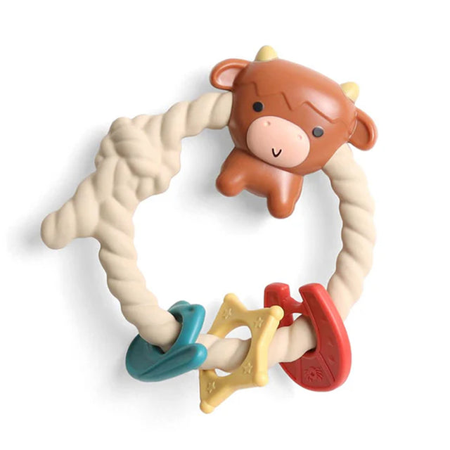 Teething ring with cow design and colorful teethers on a white background