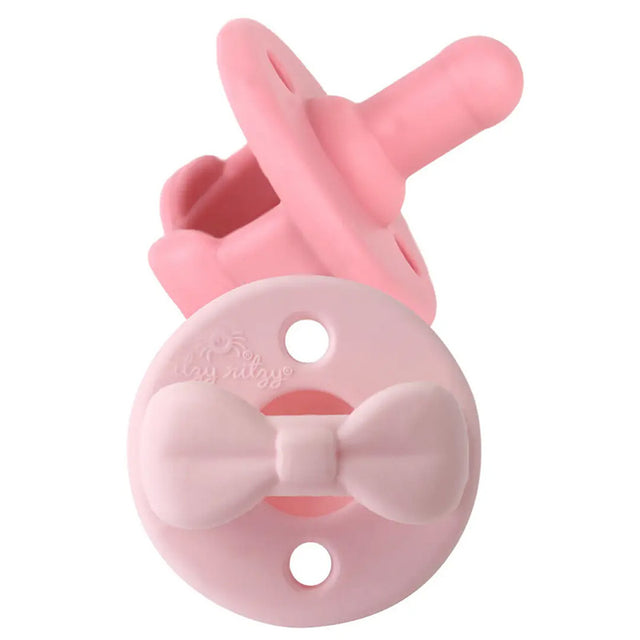 pink pacifier on white background