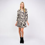 Woman wearing a patterned dress on a white background