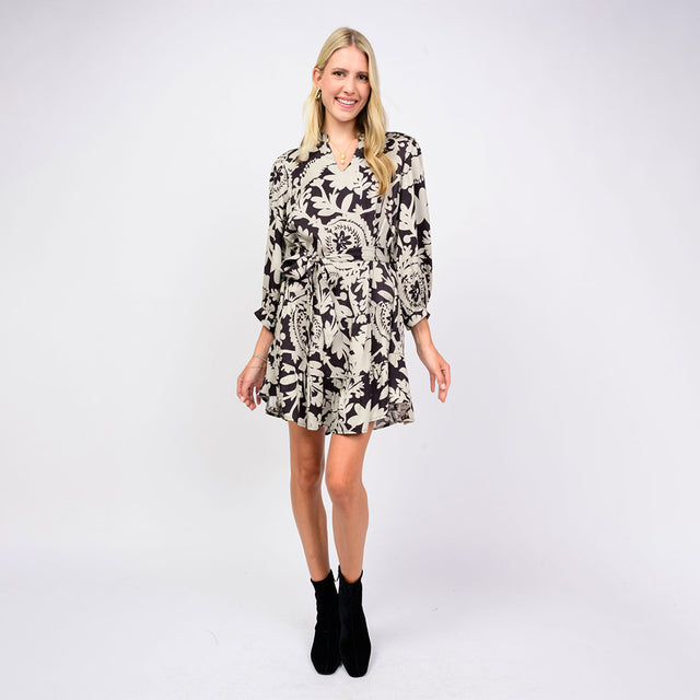 Woman wearing a patterned dress on a white background