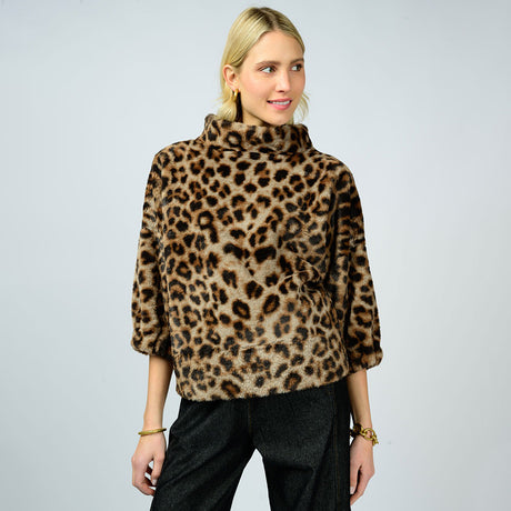 Woman wearing a leopard print sweater on a plain background