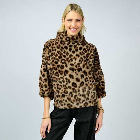 a woman wearing a leopard print faux fur pullover with black pants