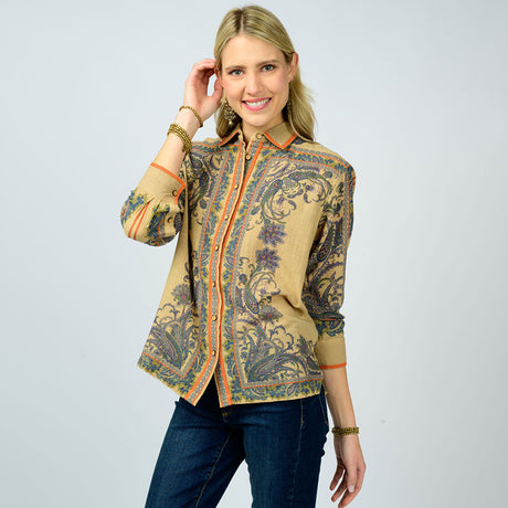 Woman wearing a patterned top on a plain background