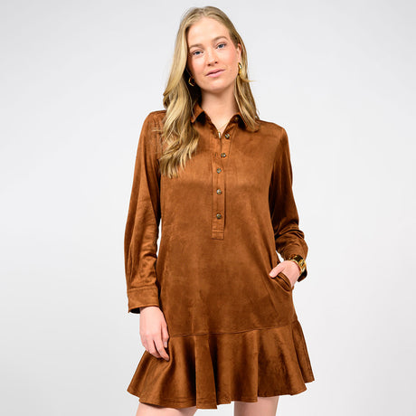 Woman wearing a brown dress with long sleeves on a white background