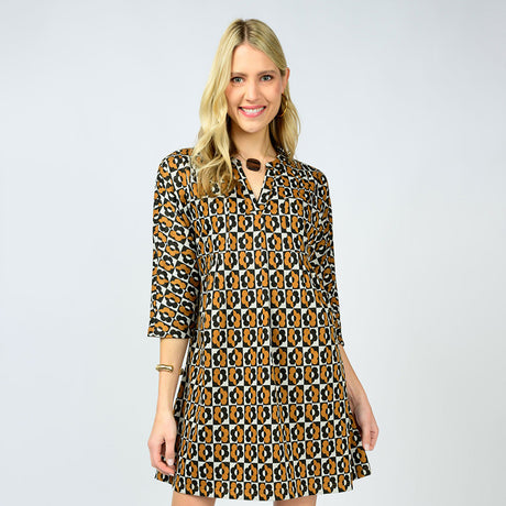 Woman wearing a patterned dress on a plain background