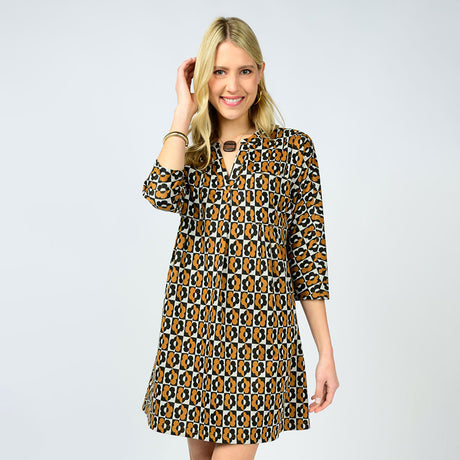 Woman wearing a patterned dress on a plain background