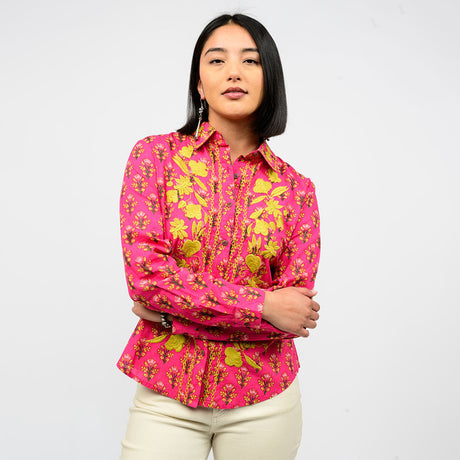 Woman wearing a pink floral shirt against a white background