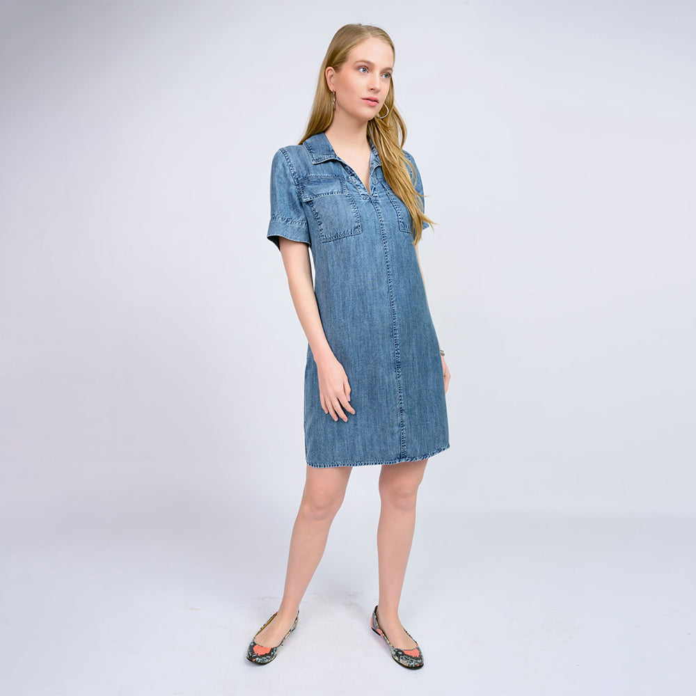 Woman wearing a denim dress on a white background