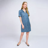 Woman wearing a denim dress on a white background