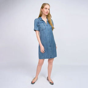 Woman wearing a denim dress on a white background