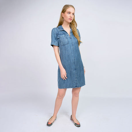 Woman wearing a denim dress on a white background